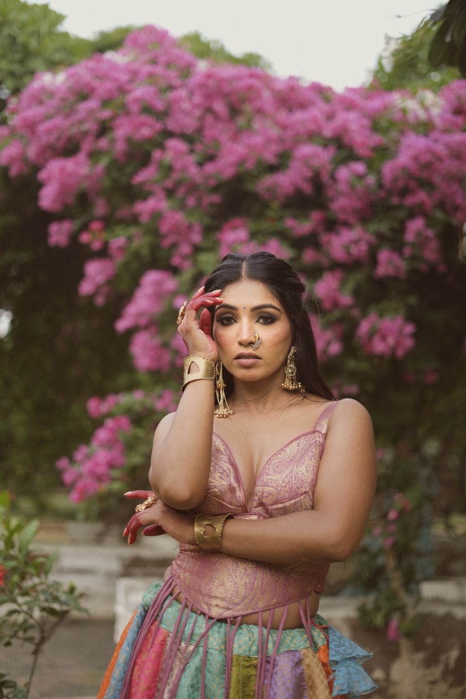 Model posing in front of pink bougainvillea