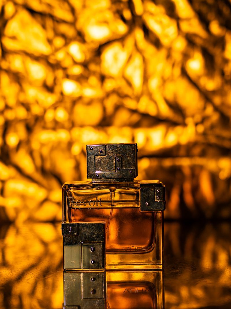Perfume bottle lit in warm gold light